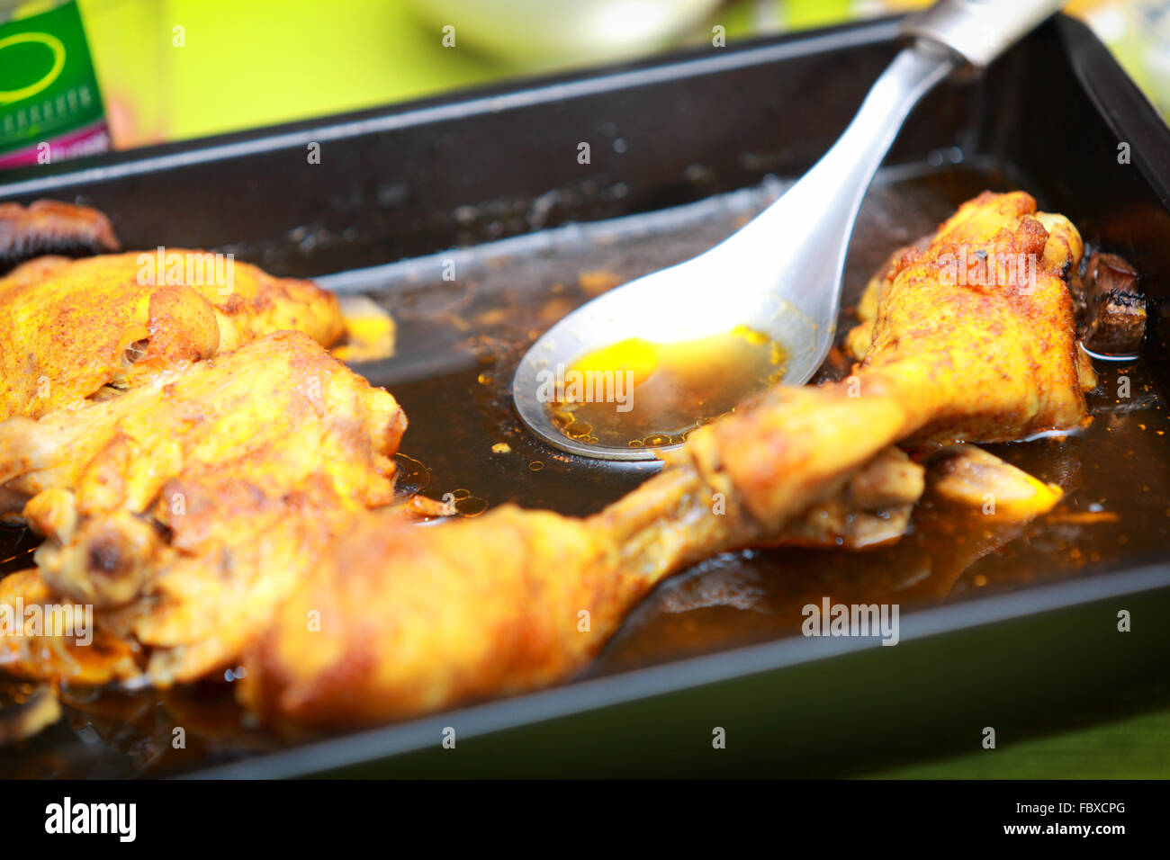 meat food chicken roasted drumsticks legs in black tin on table. Dinner