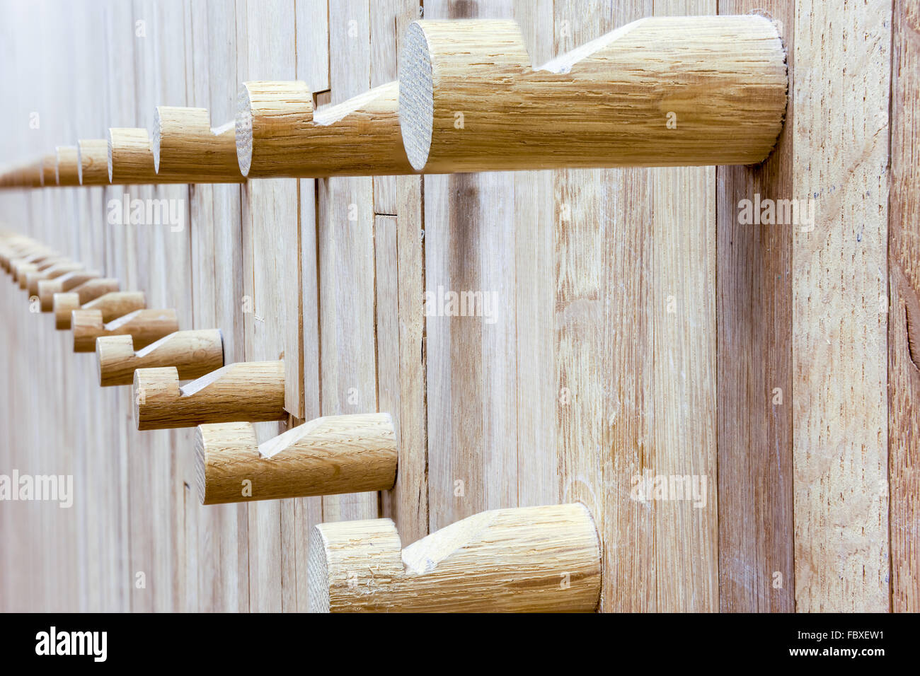 an wall from wood whit some coat rack in wood Stock Photo