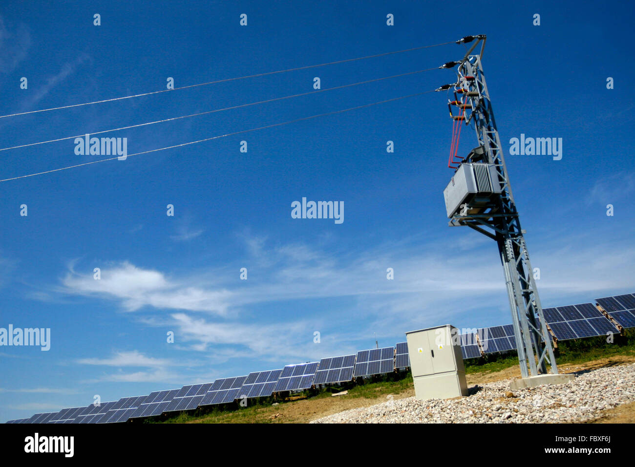 Power lines and wires, Electrical transformer on pole and solar panels Stock Photo