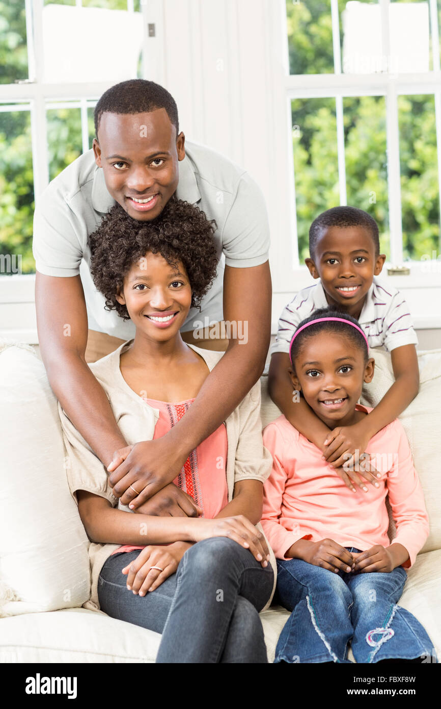 Smiling family sitting on the couch together Stock Photo - Alamy