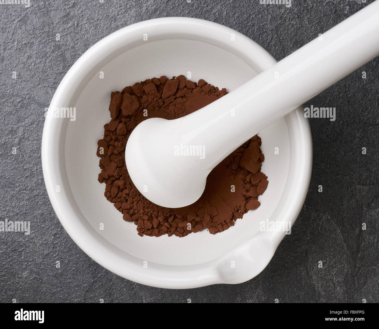 Cocoa Powder in a Mortar with Pestle Stock Photo