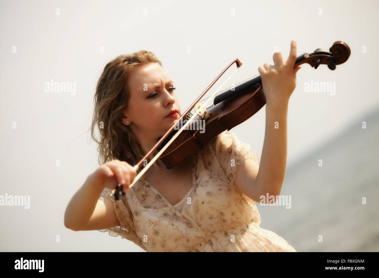 Portrait blonde girl with a violin outdoor Stock Photo - Alamy