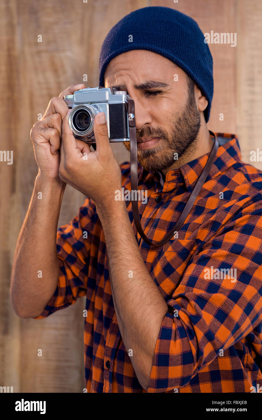 Hipster businessman photographing through camera Stock Photo Alamy