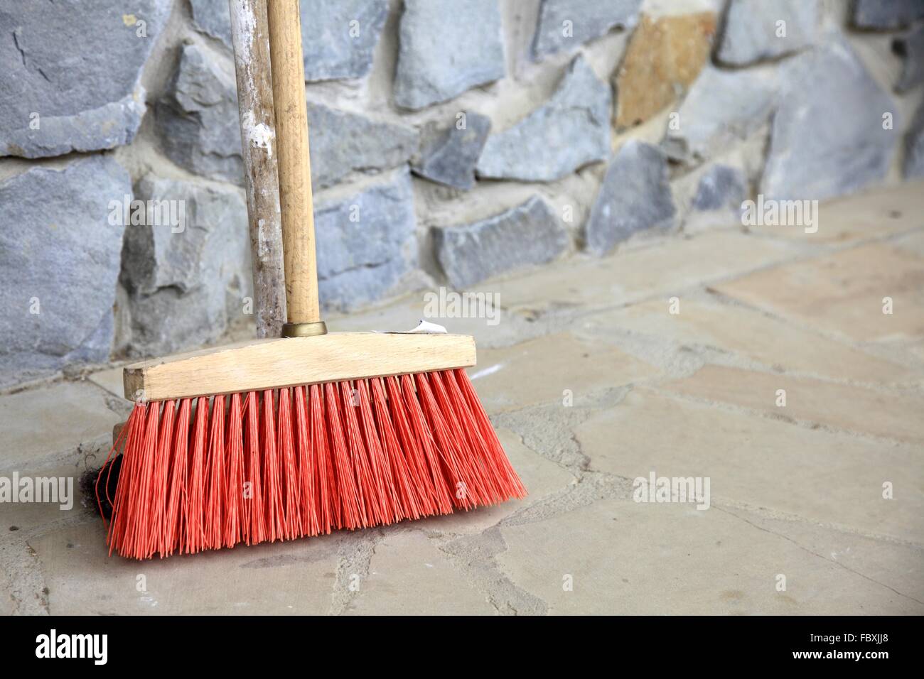 large broom on wall outdoor housework Stock Photo Alamy