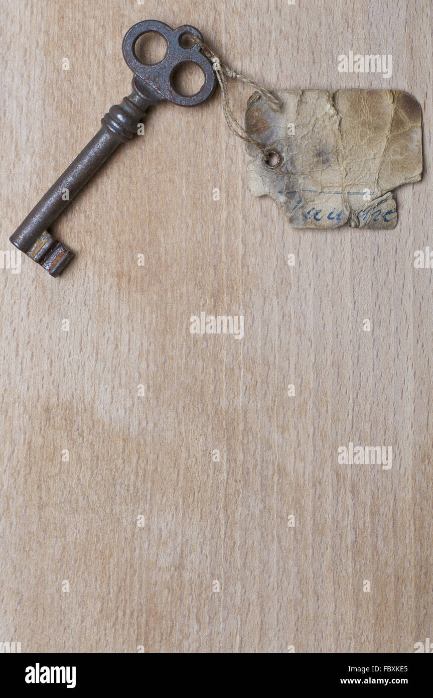 Antique Key with Label on Wood Stock Photo