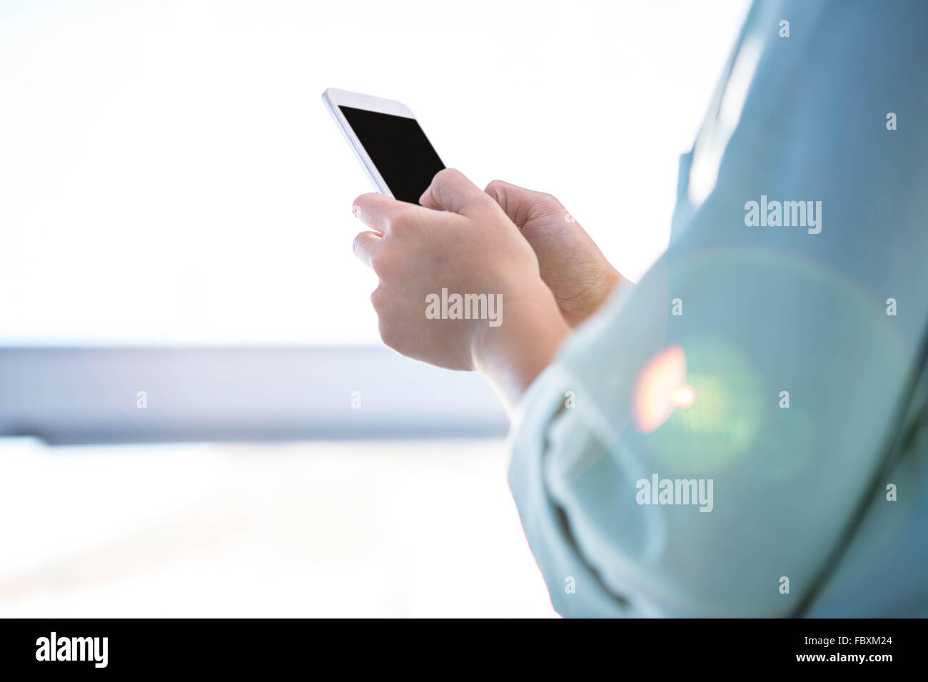 Rear view of a businesswoman using her smartphone Stock Photo
