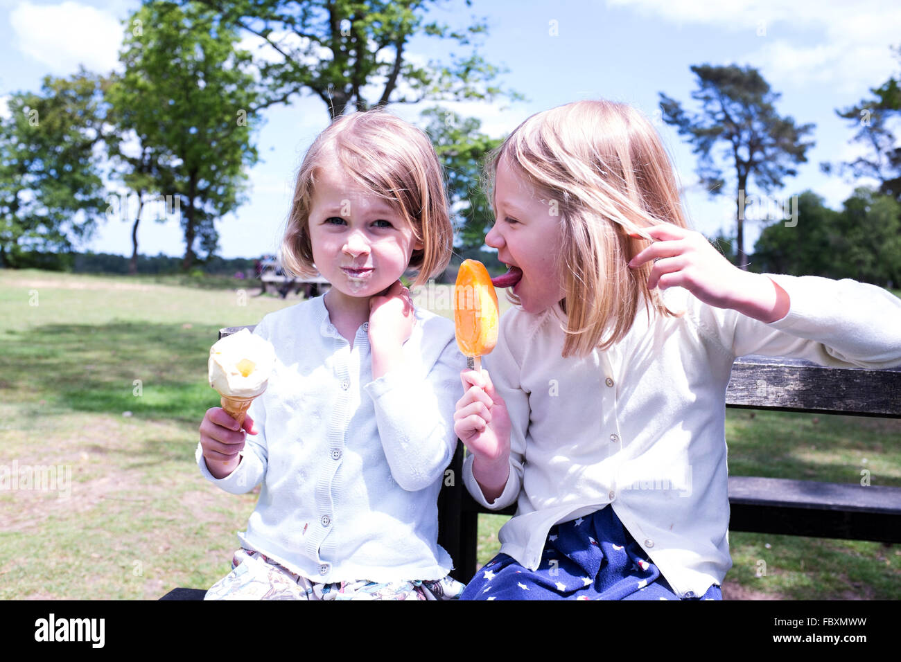 Sister day out with ice cream and lolly Stock Photo