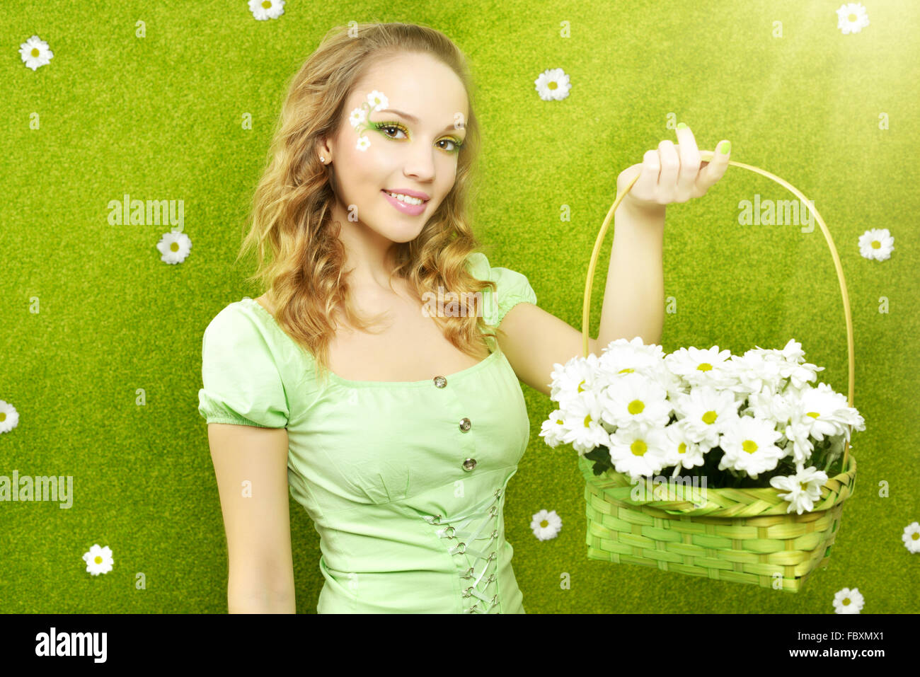 Smiling girl with a basket of flowers Stock Photo - Alamy