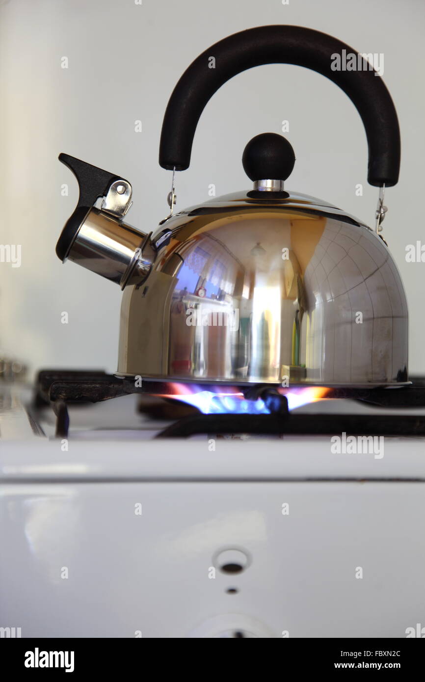 tea kettle on a flaming gas stove Stock Photo Alamy