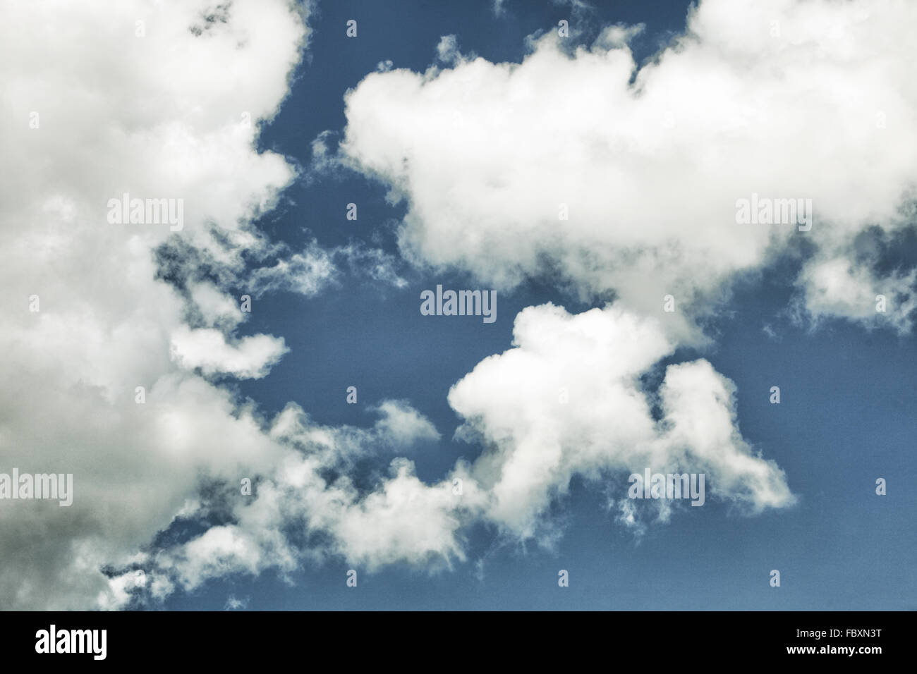 Skyscape. Deep blue sky with white clouds. Nature background. Stock Photo