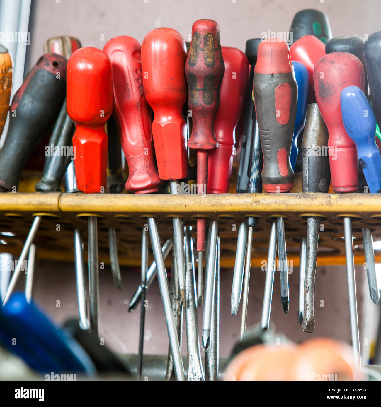 Assortment Of Tools Hanging On Wall Screwdrivers In Mechanic