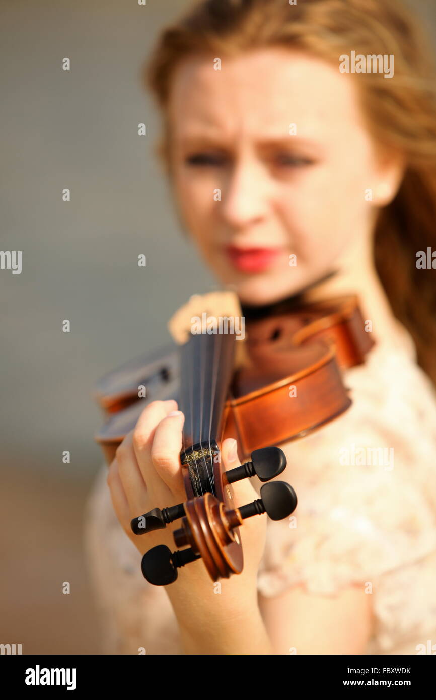 Portrait blonde girl with a violin outdoor Stock Photo - Alamy