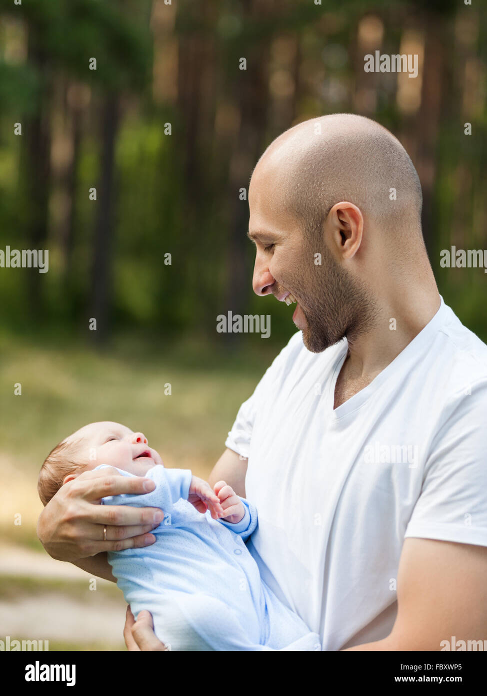 Father and newborn baby son walking outdoor Stock Photo