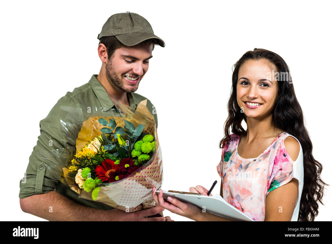 Woman signing for bouquet delivery with smiling postman Stock Photo