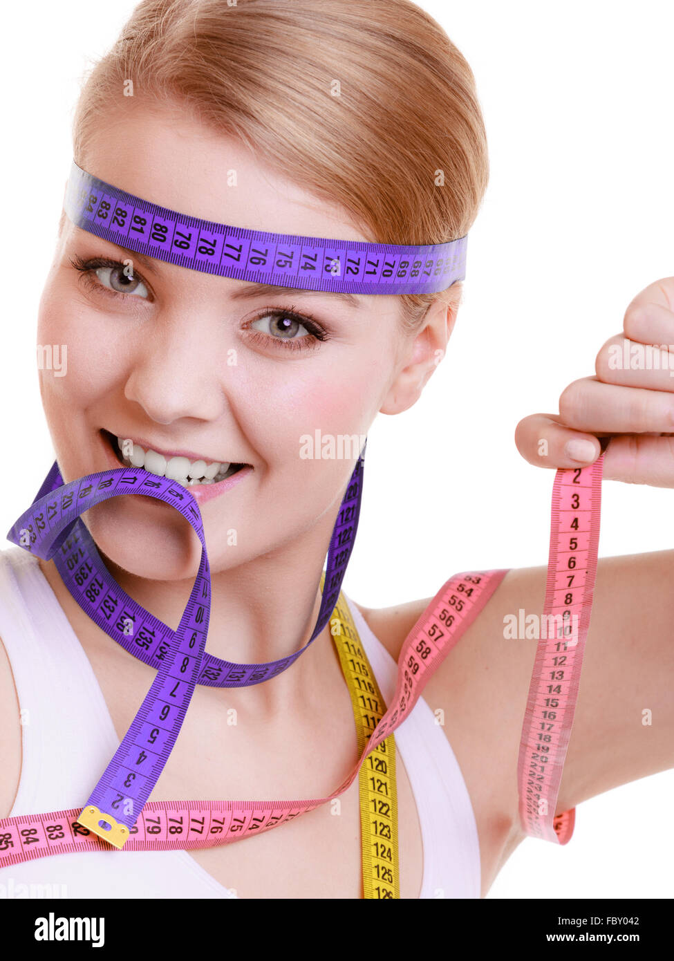 Surprised excess weight caucasian woman wrap measure tape around her waist.  High quality photo image. Stock Photo by ©kazzakova 558018968