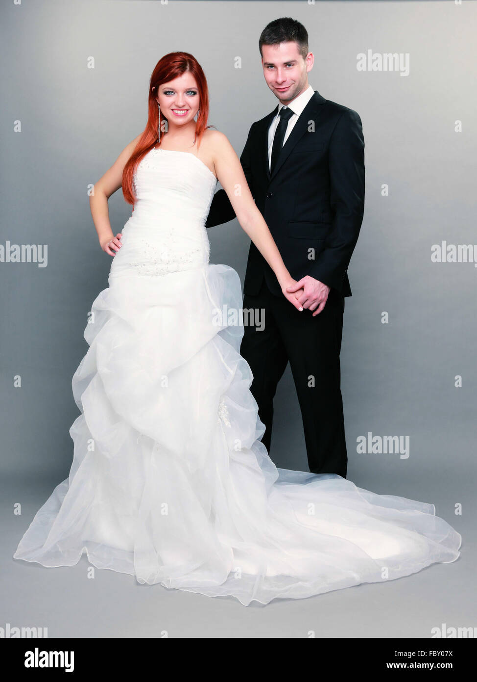 Happy married couple bride groom on gray background Stock Photo Alamy