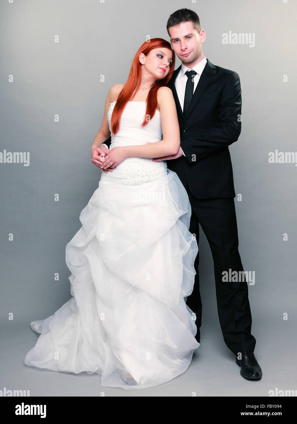 Happy married couple bride groom on gray background Stock Photo Alamy