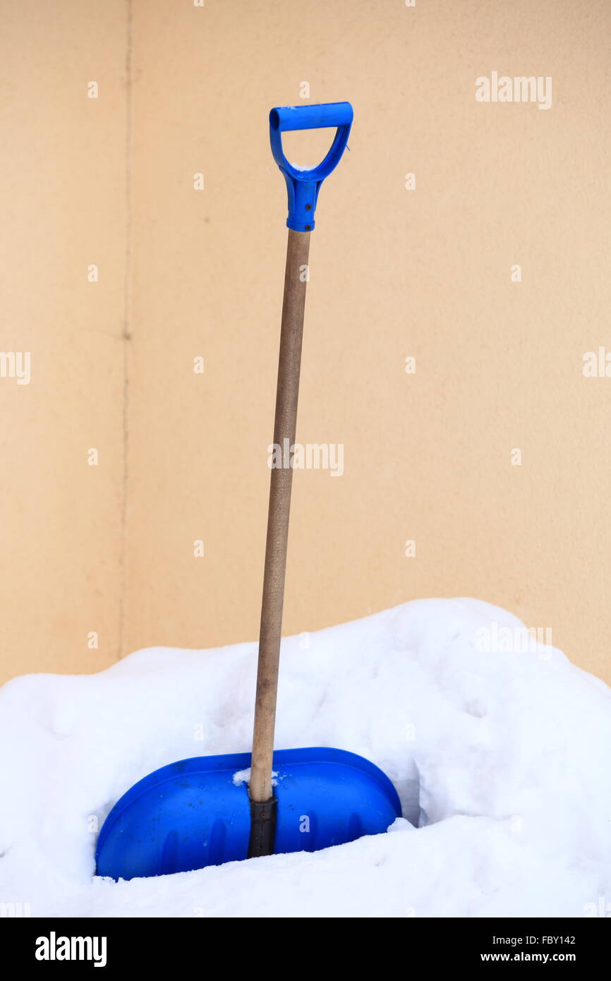 blue snow shovel standing up in deep snow Stock Photo - Alamy