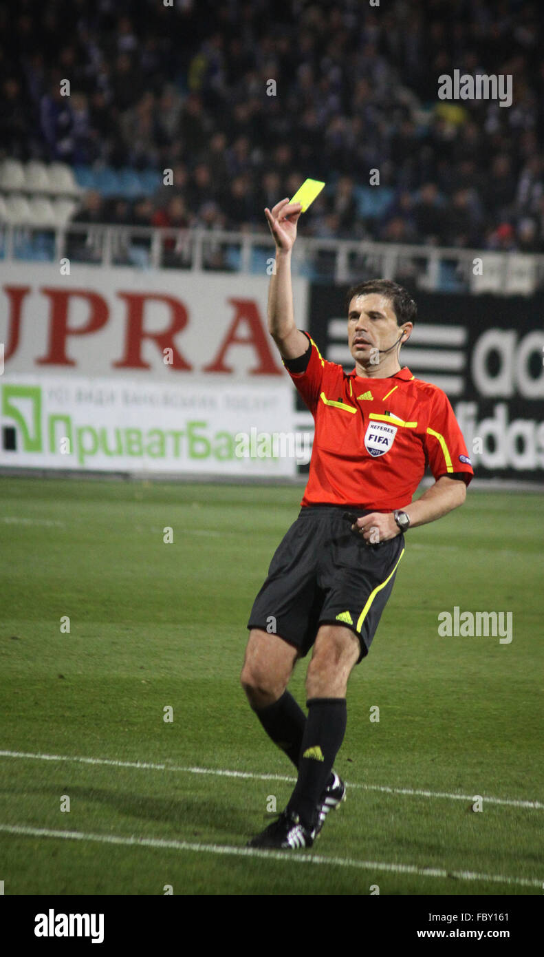Referee Milorad Mazic shows the yellow card during UEFA Europa League game between Dynamo and Besiktas Stock Photo