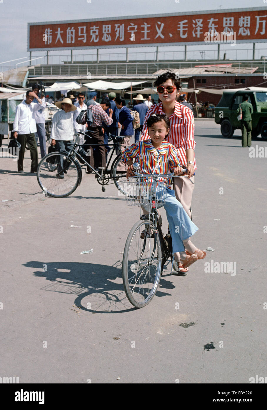 Modern style clothes of mother and daughter on bicycle, Yinchuan, Ningxia Autonomous Region, China Stock Photo