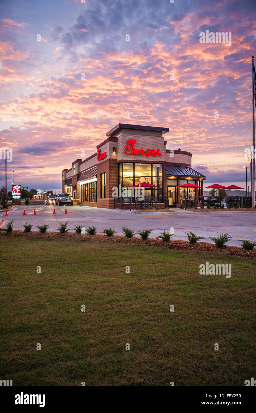 Chick-fil-A restaurant with breakfast drive-thru traffic at sunrise in Muskogee, Oklahoma. Stock Photo