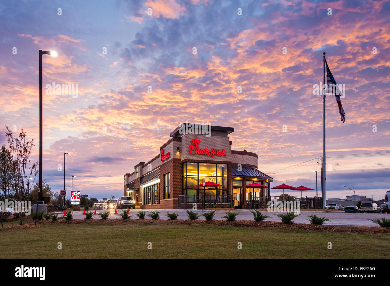 Chick-fil-A restaurant with breakfast drive-thru traffic at sunrise in Muskogee, Oklahoma. Stock Photo