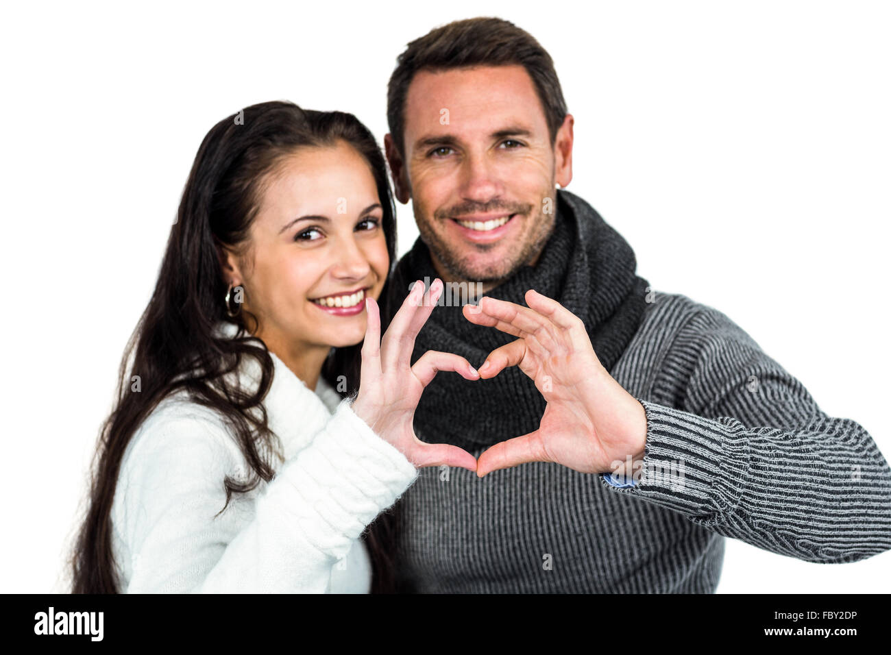 Smiling couple making heart shape with hands Stock Photo - Alamy