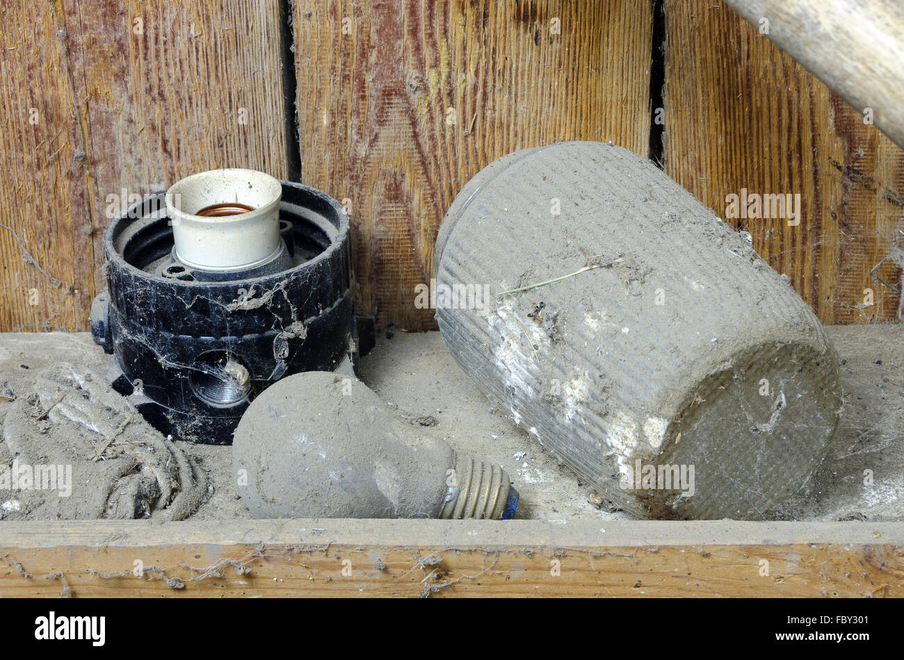 dusty and cobwebbed old parts of a lamp Stock Photo