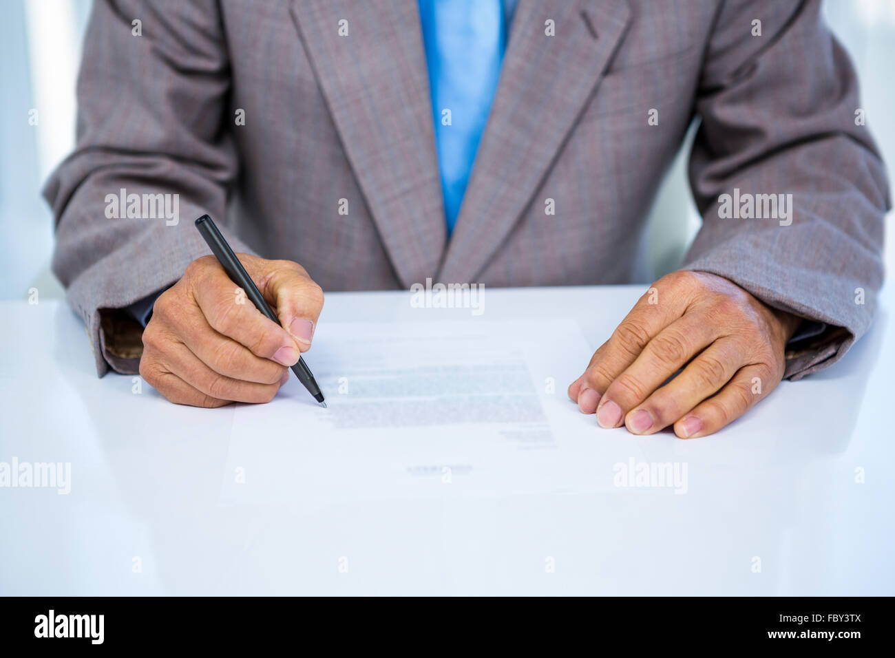 Serious businessman making notes Stock Photo - Alamy