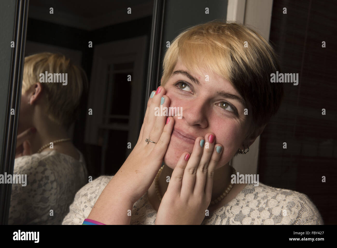 Decatur, Georgia, USA. 1st Jan, 2016. EMMA GRACE KOETTER displays her self-manicure with colors of the transgender flag. 'Genderqueer' is an umbrella term that describes all non-binary gender identities including agender, genderfluid, third gender, androgyne, and a whole lot more. 'I totally identify as being genderqueer, ' she said. (Credit Image: © Robin Rayne Nelson/zReportage.com via ZUMA Press) Stock Photo