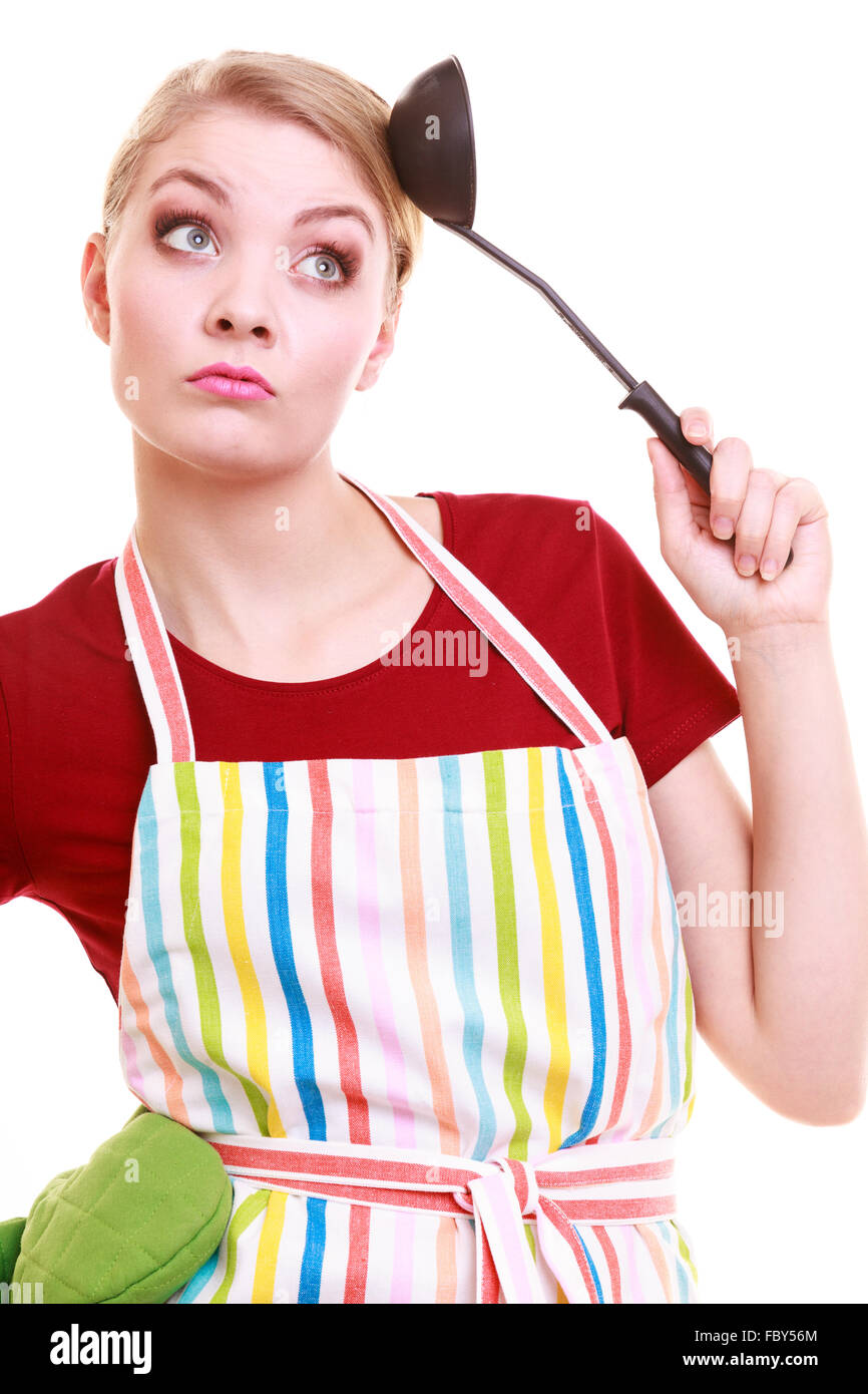Funny housewife or cook chef in colorful kitchen apron with ladle Stock Photo