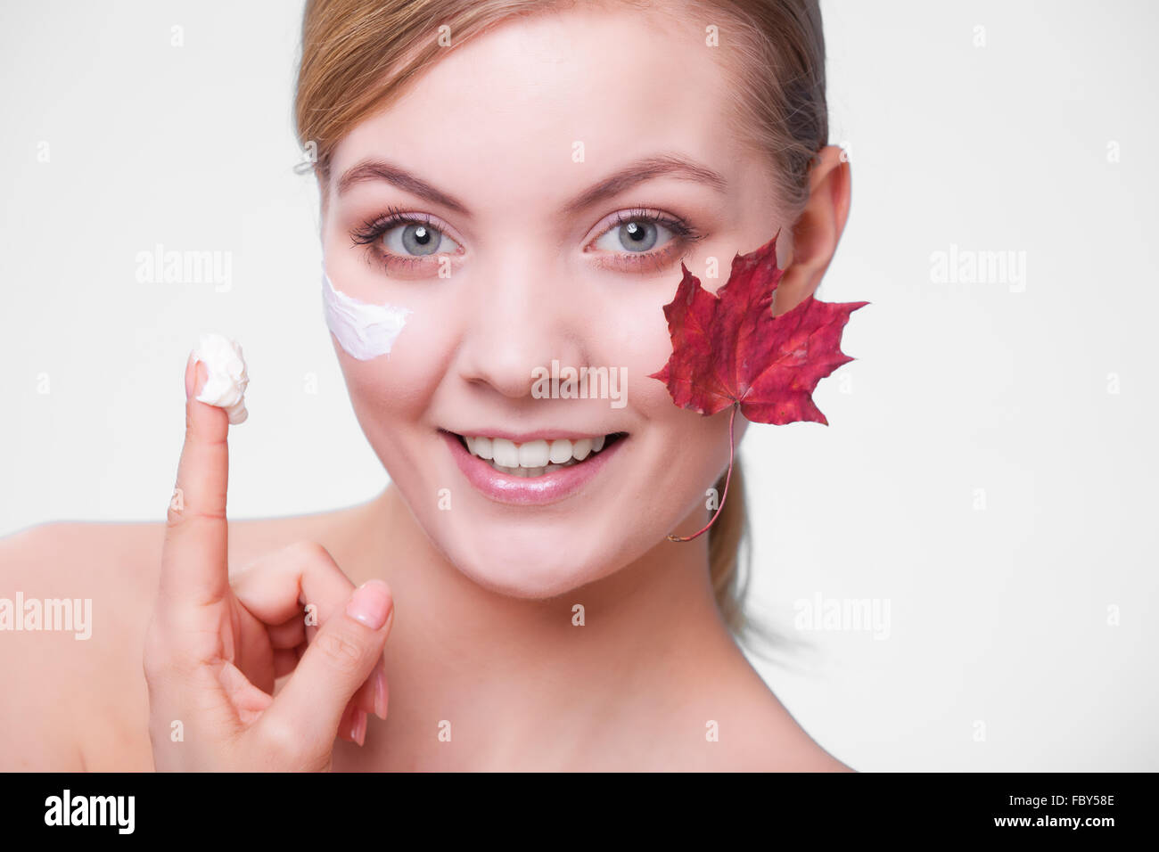 Skin care. Face of young woman girl with red maple leaf Stock Photo Alamy