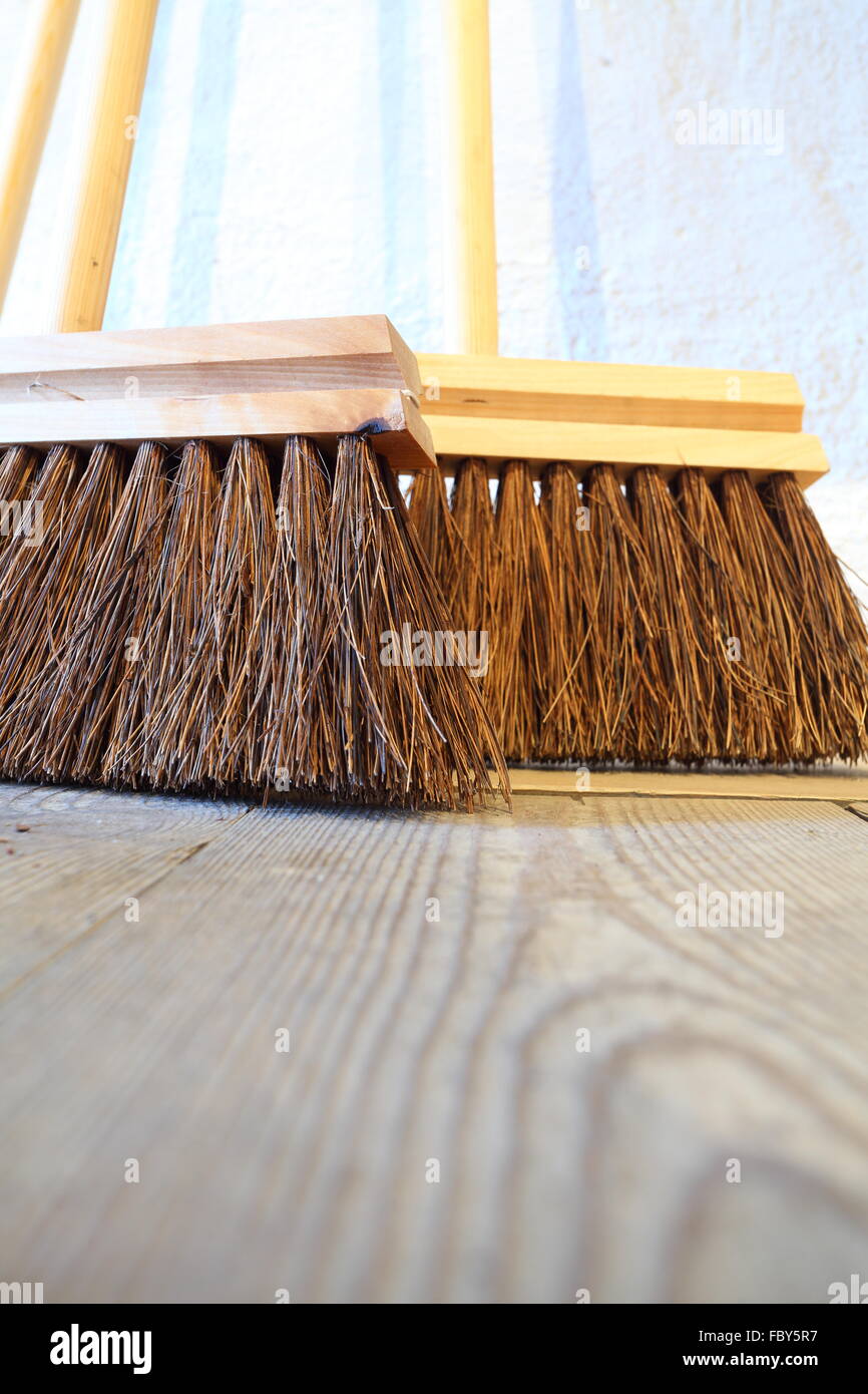 large brooms on wooden floor housework Stock Photo Alamy
