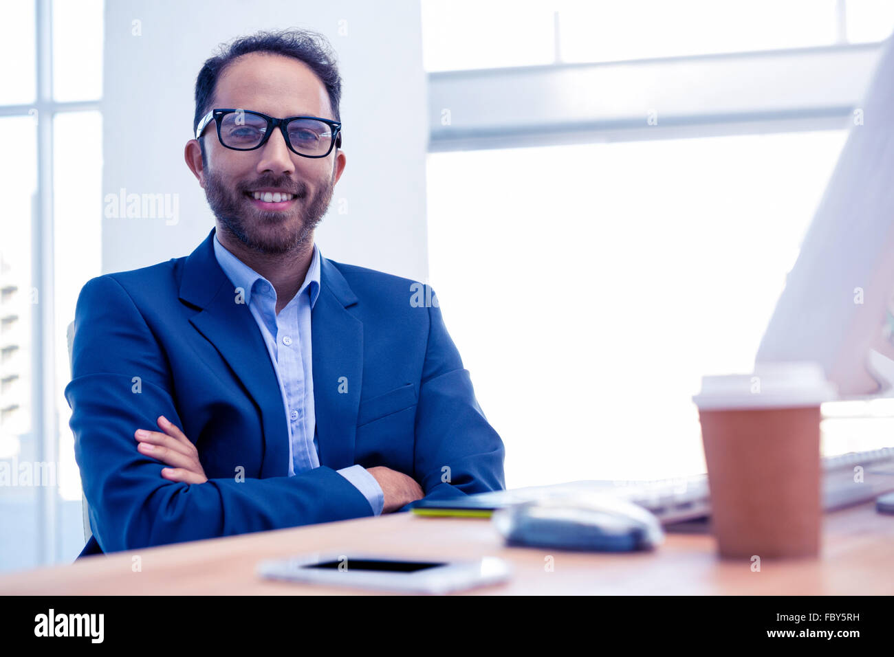Portrait of happy businessman with arms crossed in office Stock Photo ...