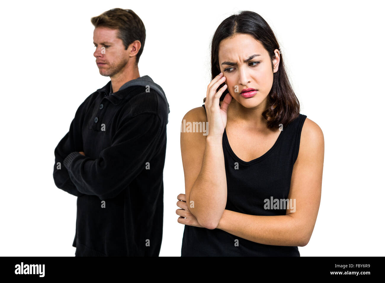Depressed couple standing against white background Stock Photo - Alamy