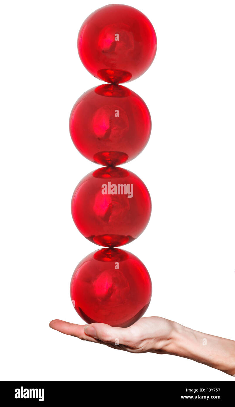 Four balls balance on hand Stock Photo