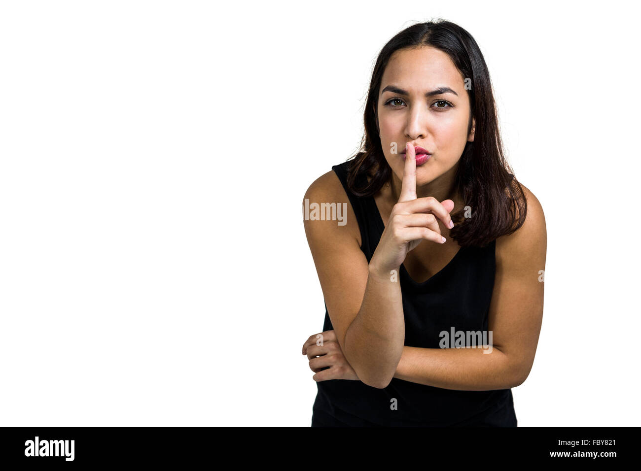 Portrait of woman with finger on lips Stock Photo