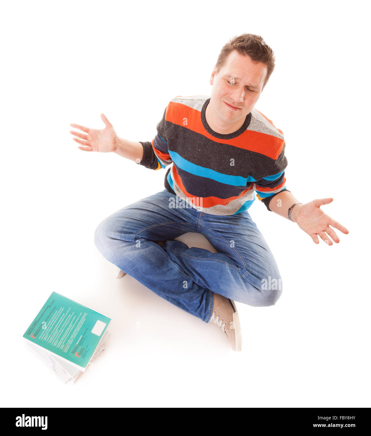 Exhausted tired college student with pile of books studying for exams