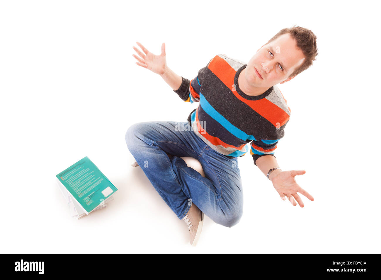 Exhausted tired college student with pile of books studying for exams isolated on white background Stock Photo