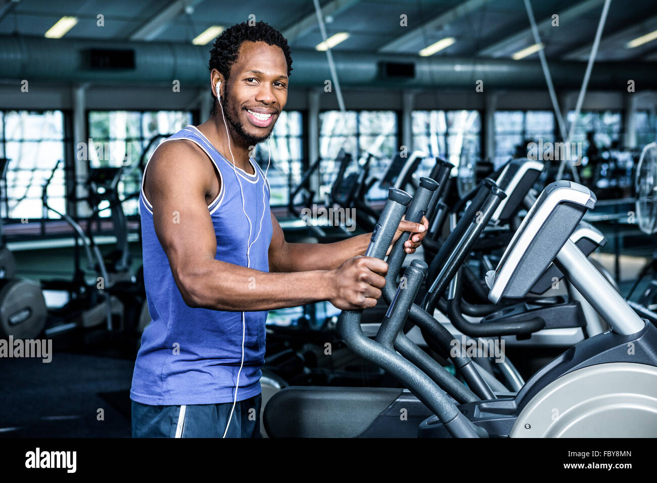 Smiling man working out with headphones on Stock Photo