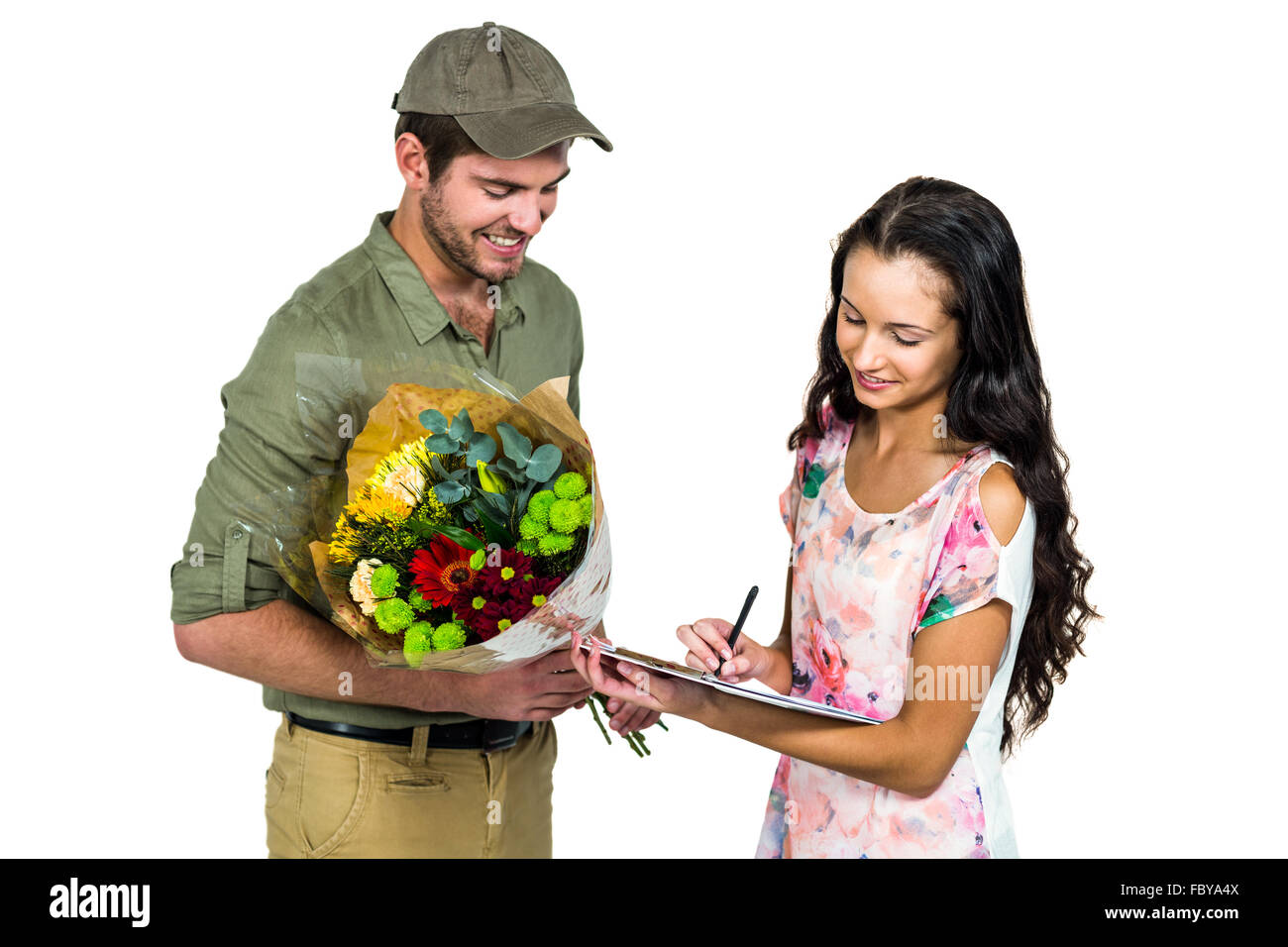 Woman signing for bouquet delivery with smiling postman Stock Photo
