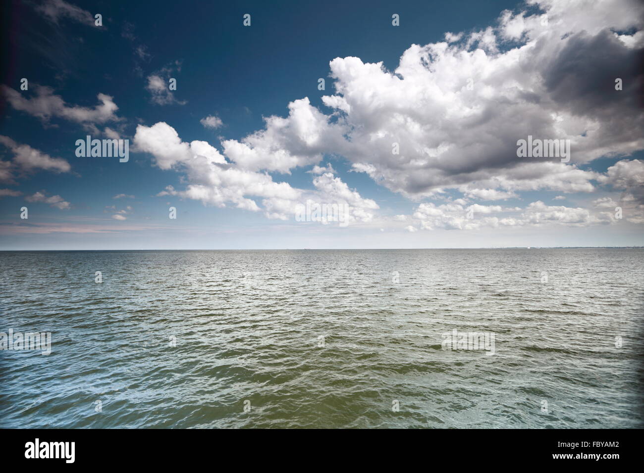 Cloudy blue sky above a surface of the sea Stock Photo - Alamy
