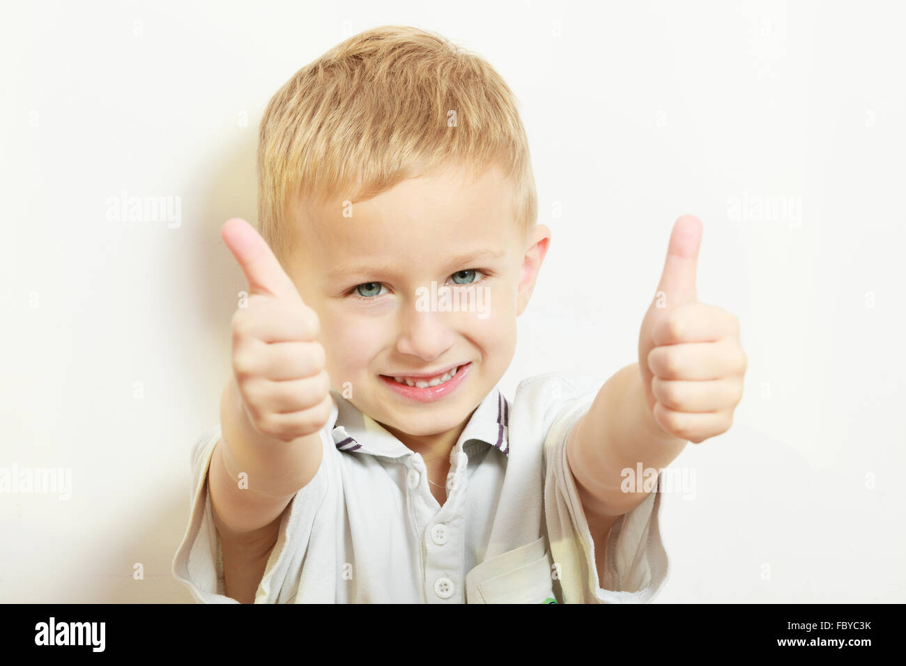 Happy childhood. Smiling blond boy child kid showing thumb up Stock ...