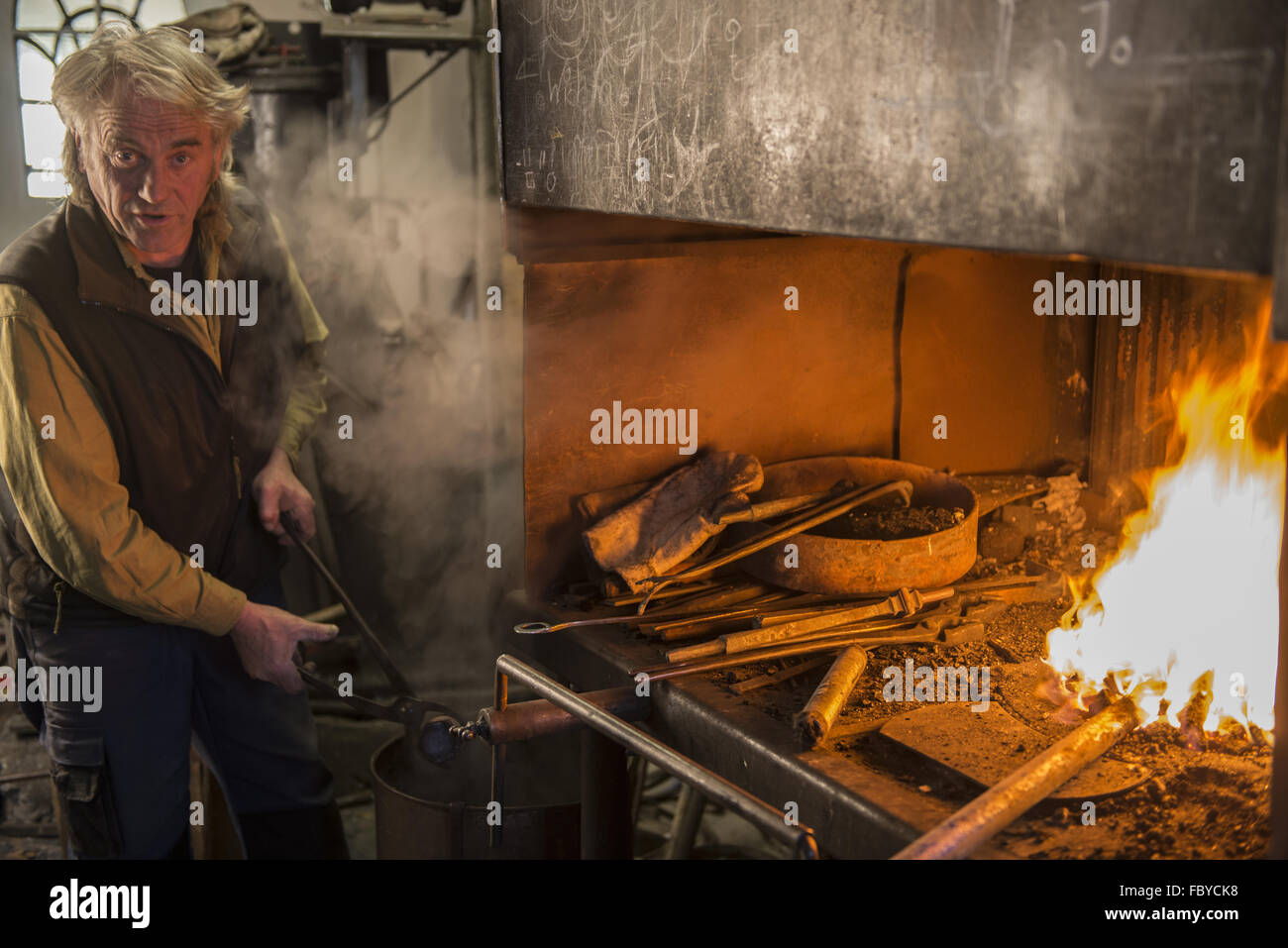 Blacksmith in front of the Fireplace Stock Photo Alamy