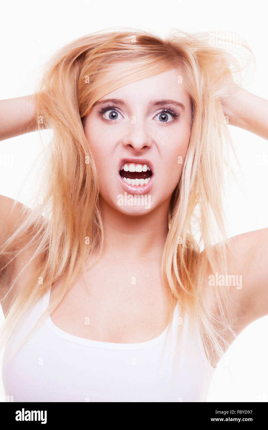 Stress. Young woman frustrated pulling her hair on white Stock Photo