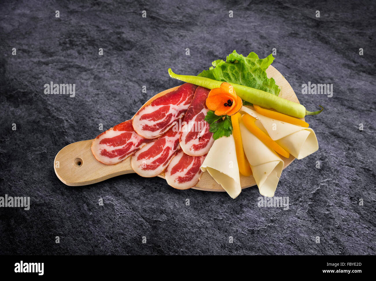 Prosciutto - parma smoked ham with vegetables on wooden board and clipping path Stock Photo