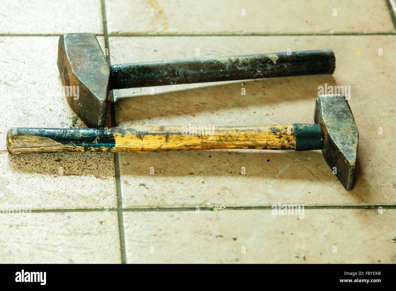 Two old sledge hammers hand tools in mechanic garage car service Stock Photo