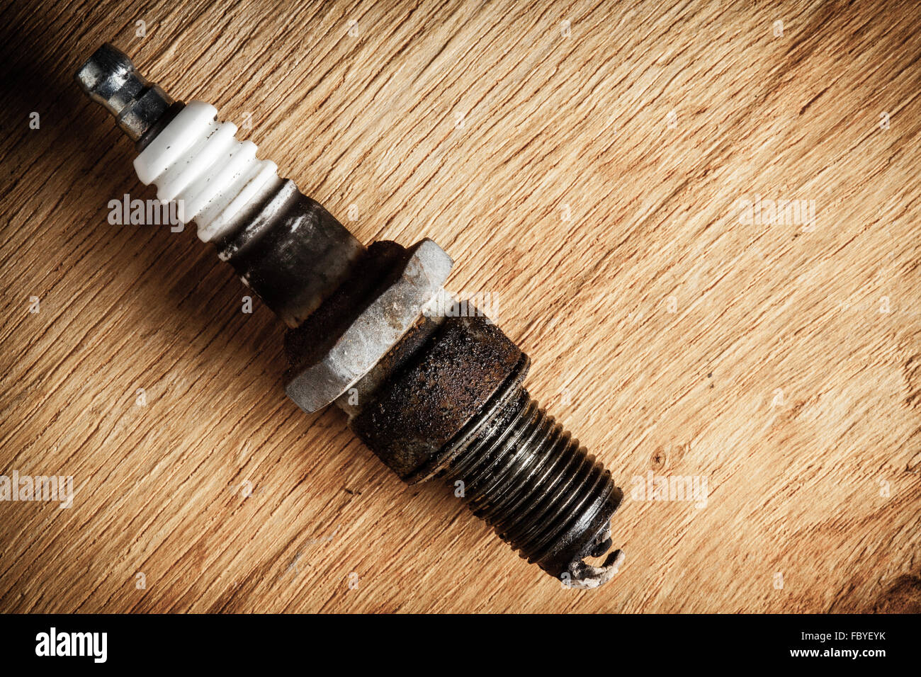 Auto service. Old spark plug as spare part of car. Stock Photo
