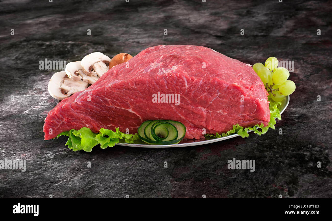 Decorated fresh raw meat - ham with mushrooms and clipping path Stock Photo