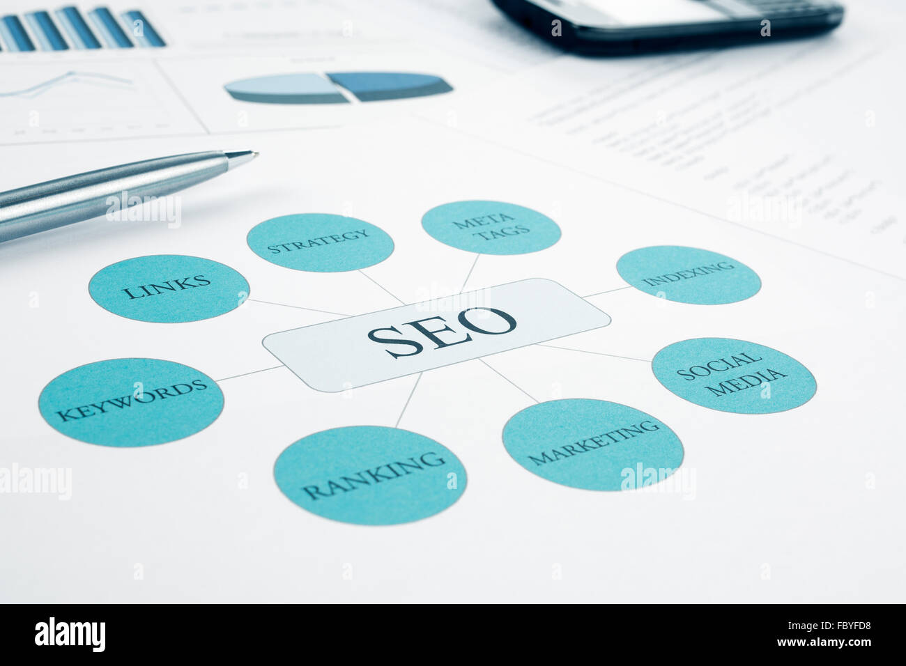 Seo business, search engine optimization concept flow chart. Pen and smartphone on background. Blue Toned Stock Photo